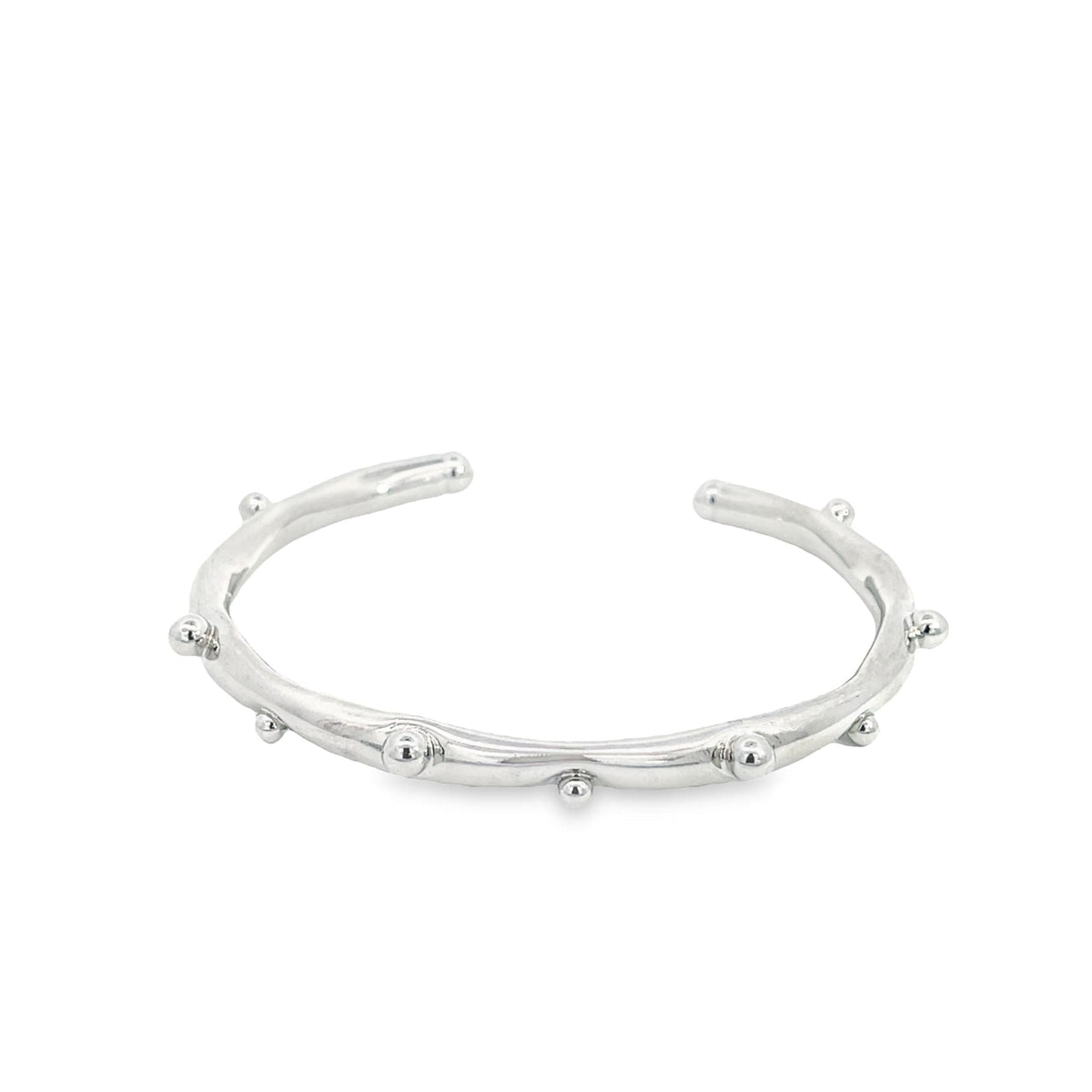 A sleek silver cuff bracelet features delicate, evenly spaced metal beads along its textured band.