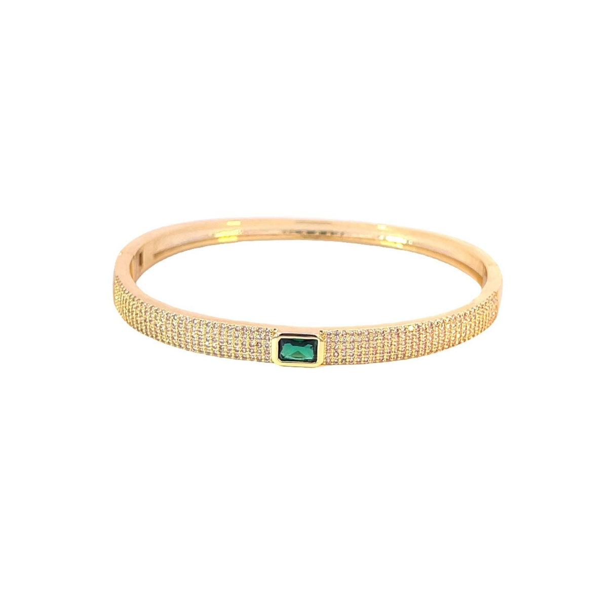 A gold pave-set crystal bangle bracelet features a vibrant emerald-cut green gemstone centered in the band.