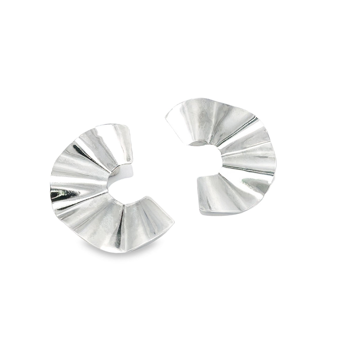 A pair of shiny silver fan-shaped statement earrings rests against a clean white background.