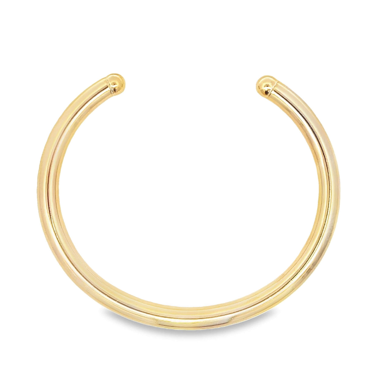 A minimalist polished gold cuff bracelet curves gracefully against a plain white background.