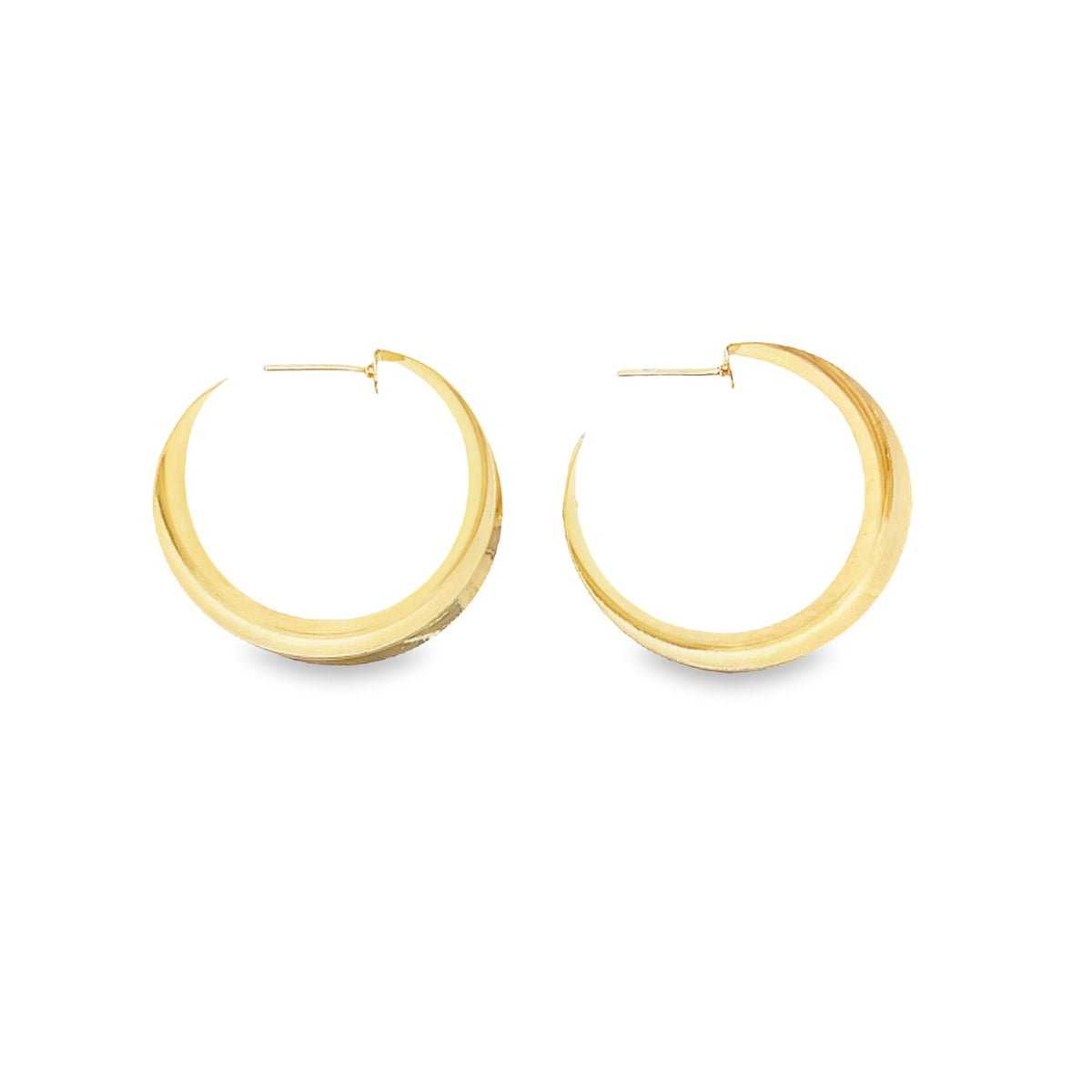 A pair of thick gold hoop earrings rests against a clean white background.