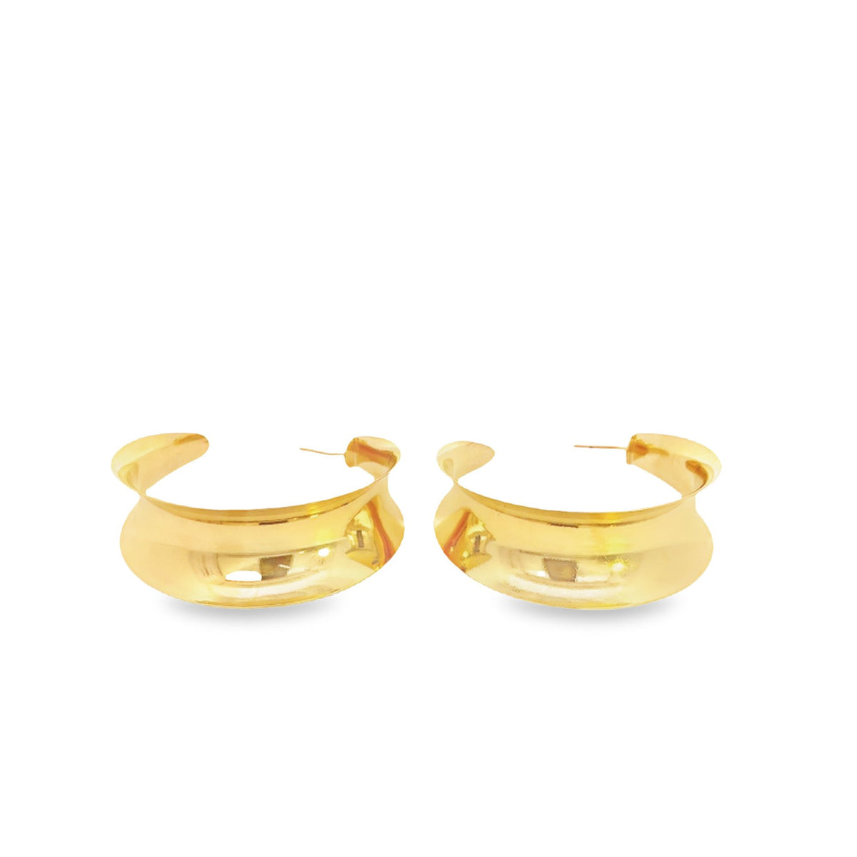 A pair of wide, polished gold hoop earrings rests against a clean white background.
