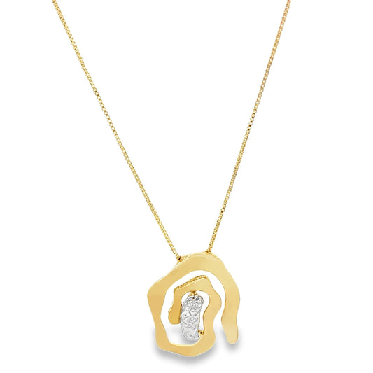 A delicate gold pendant necklace features an abstract, organic-shaped charm with a sparkling diamond accent suspended on a fine chain.