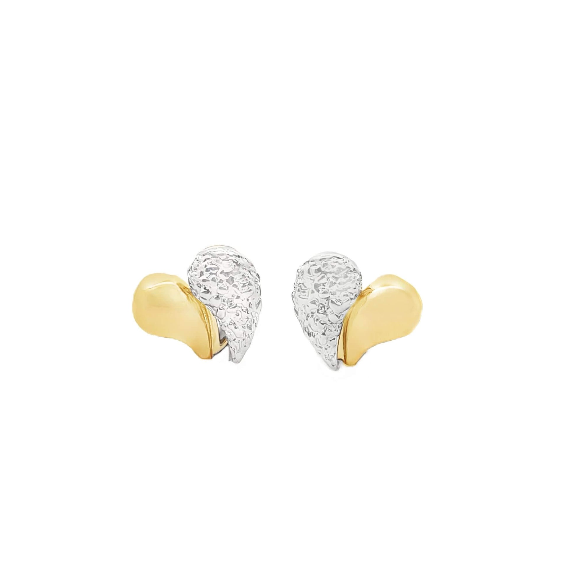 A pair of two-tone heart earrings features polished yellow gold and textured white gold halves against a clean white background.