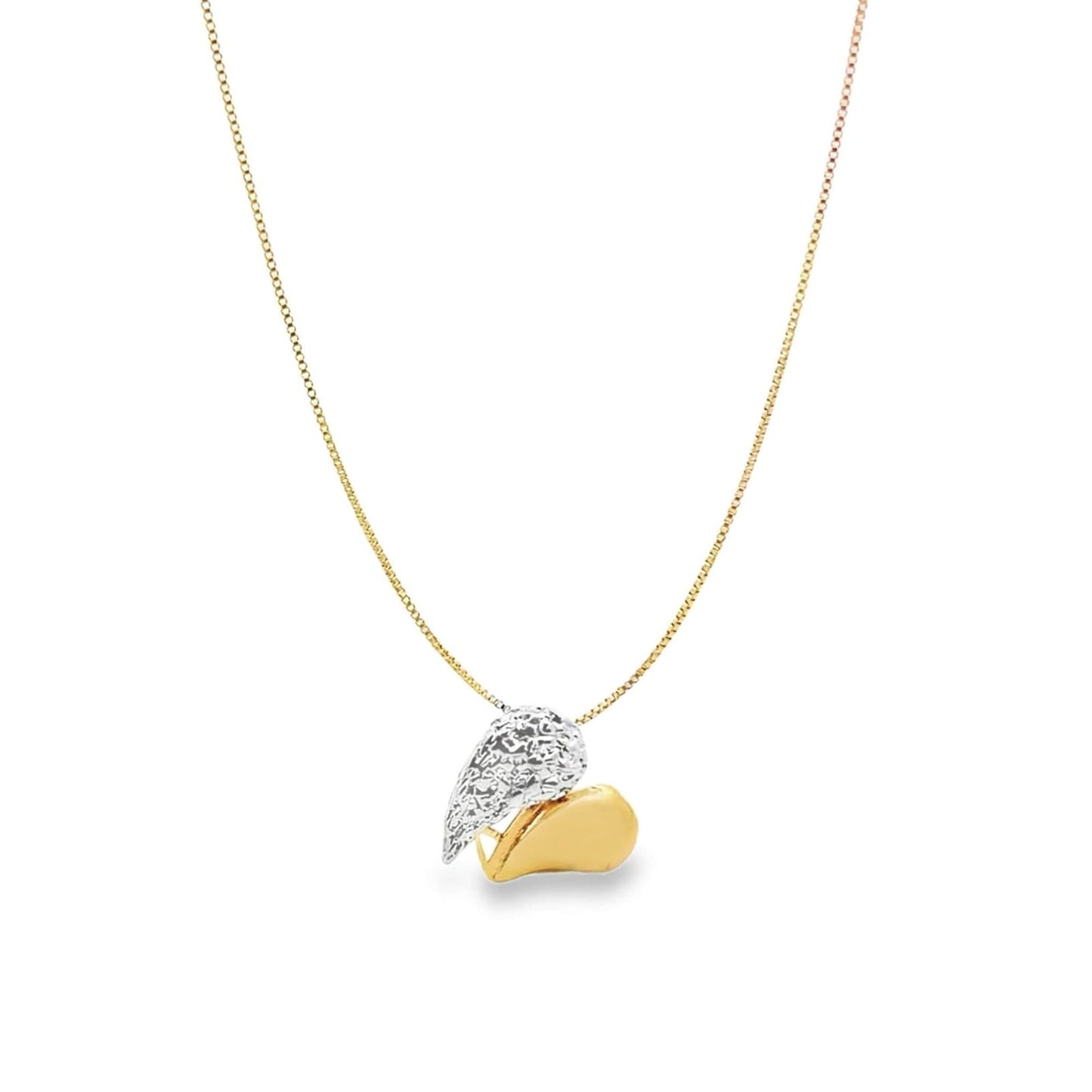 A delicate gold chain necklace hangs against a white background, featuring a two-tone pendant shaped like a textured silver wing resting next to a smooth gold heart.
