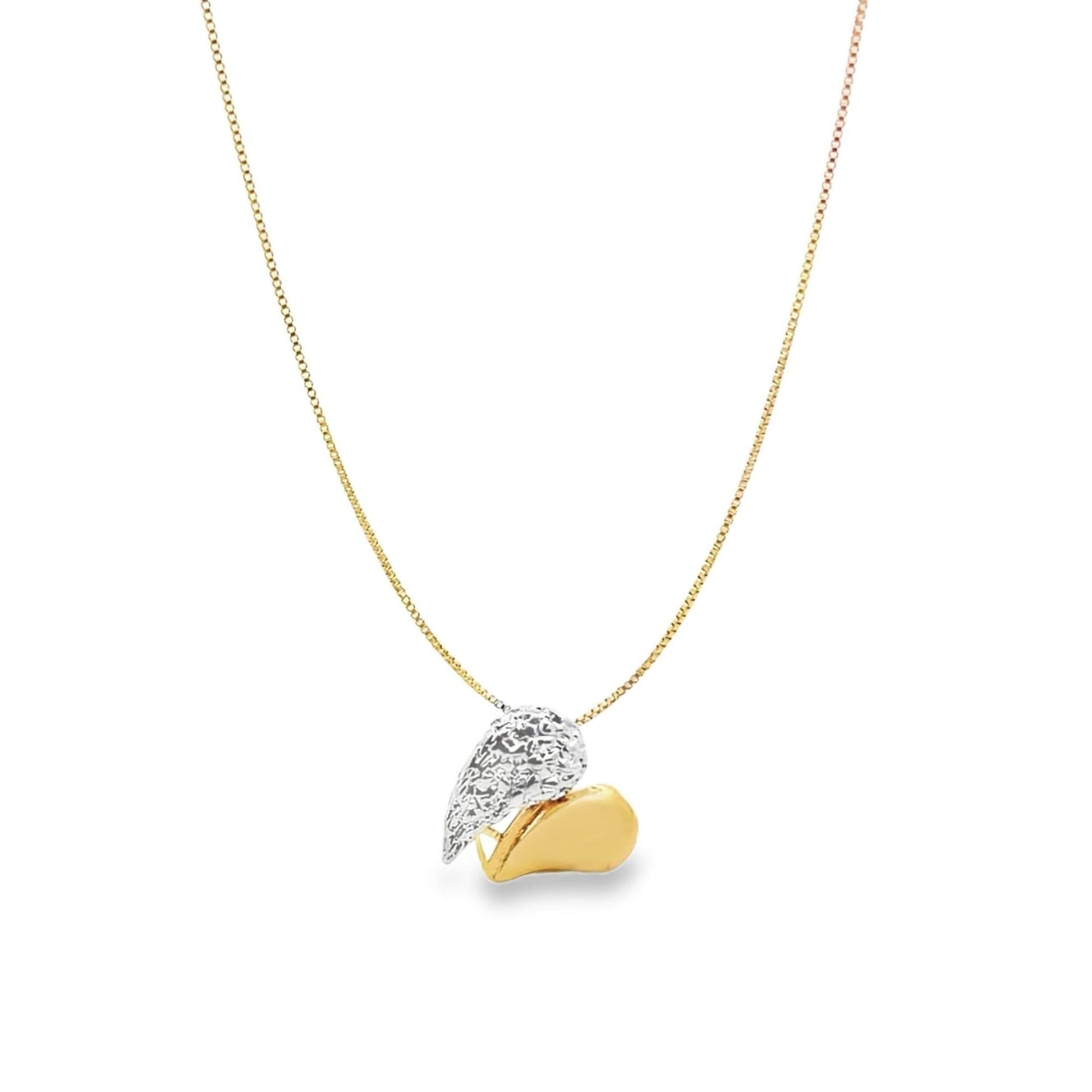 A delicate gold chain necklace hangs against a white background, featuring a two-tone pendant shaped like a textured silver wing resting next to a smooth gold heart.