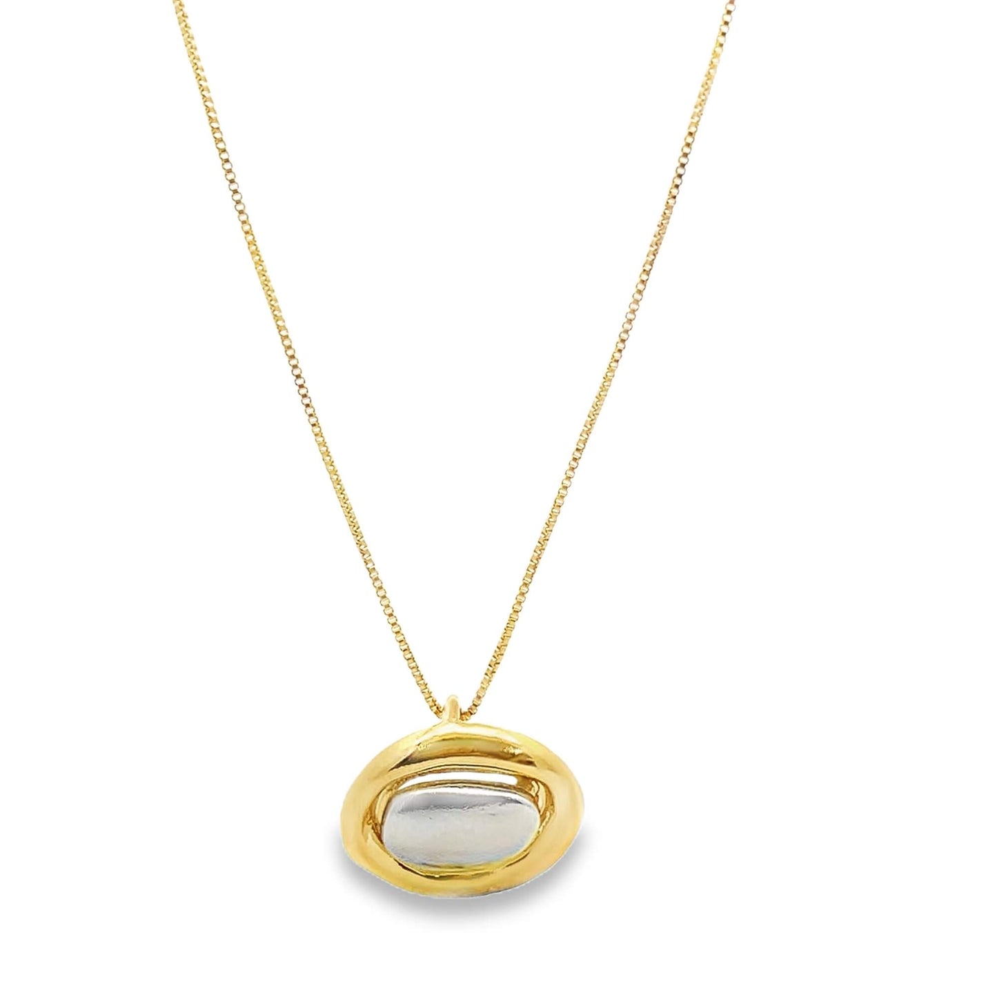 A delicate gold box chain necklace hangs against a white background, featuring a unique oval-shaped pendant with a polished silver-tone inlay surrounded by a thick gold frame.