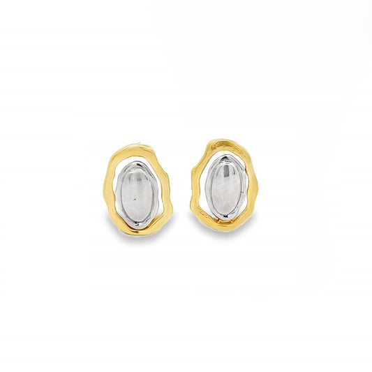 A pair of two-tone stud earrings features textured yellow gold outer frames cradling shiny silver oval centers against a clean white background.