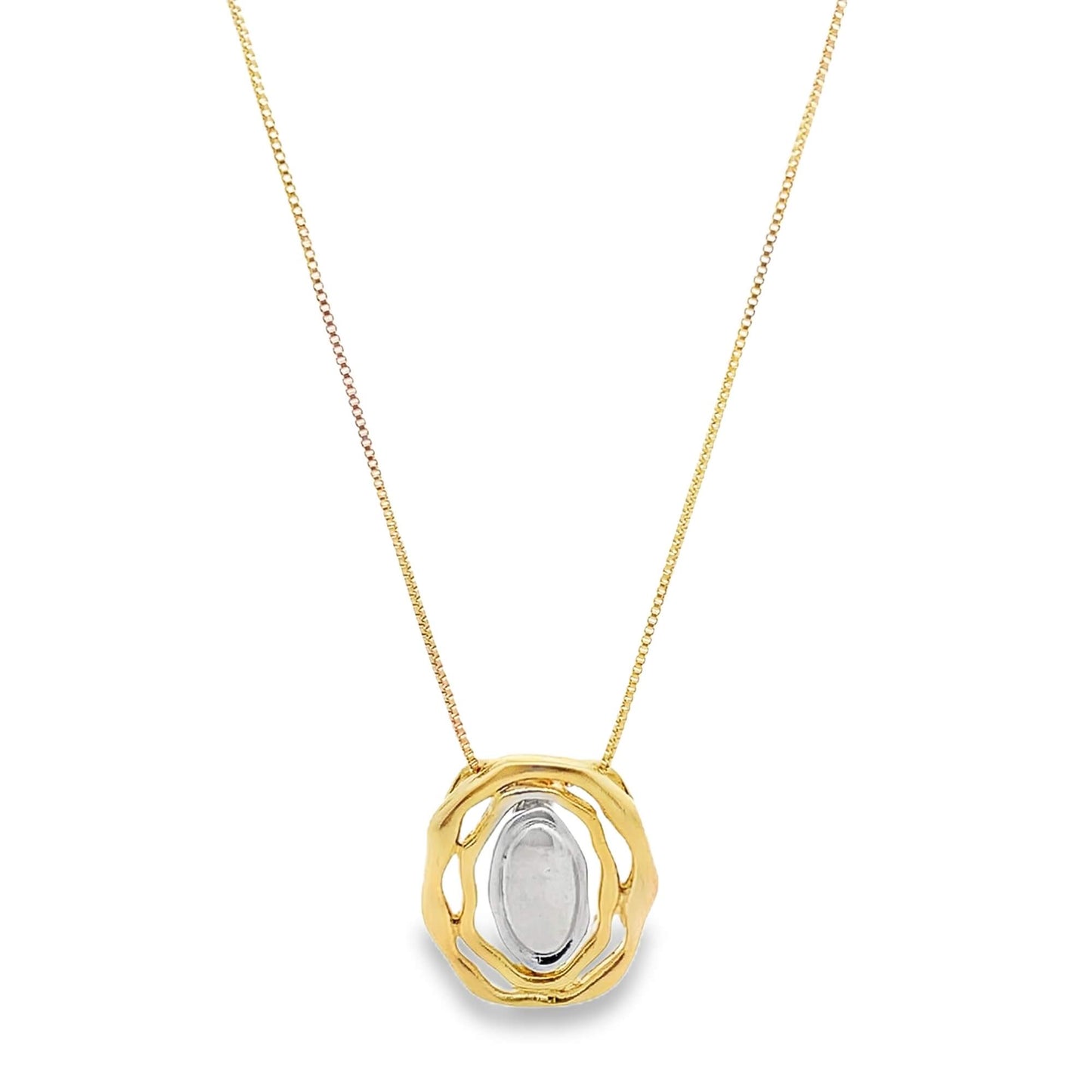 A delicate gold chain necklace hangs against a white background, featuring a unique pendant with a textured, rounded gold frame encasing a smooth silver oval center.