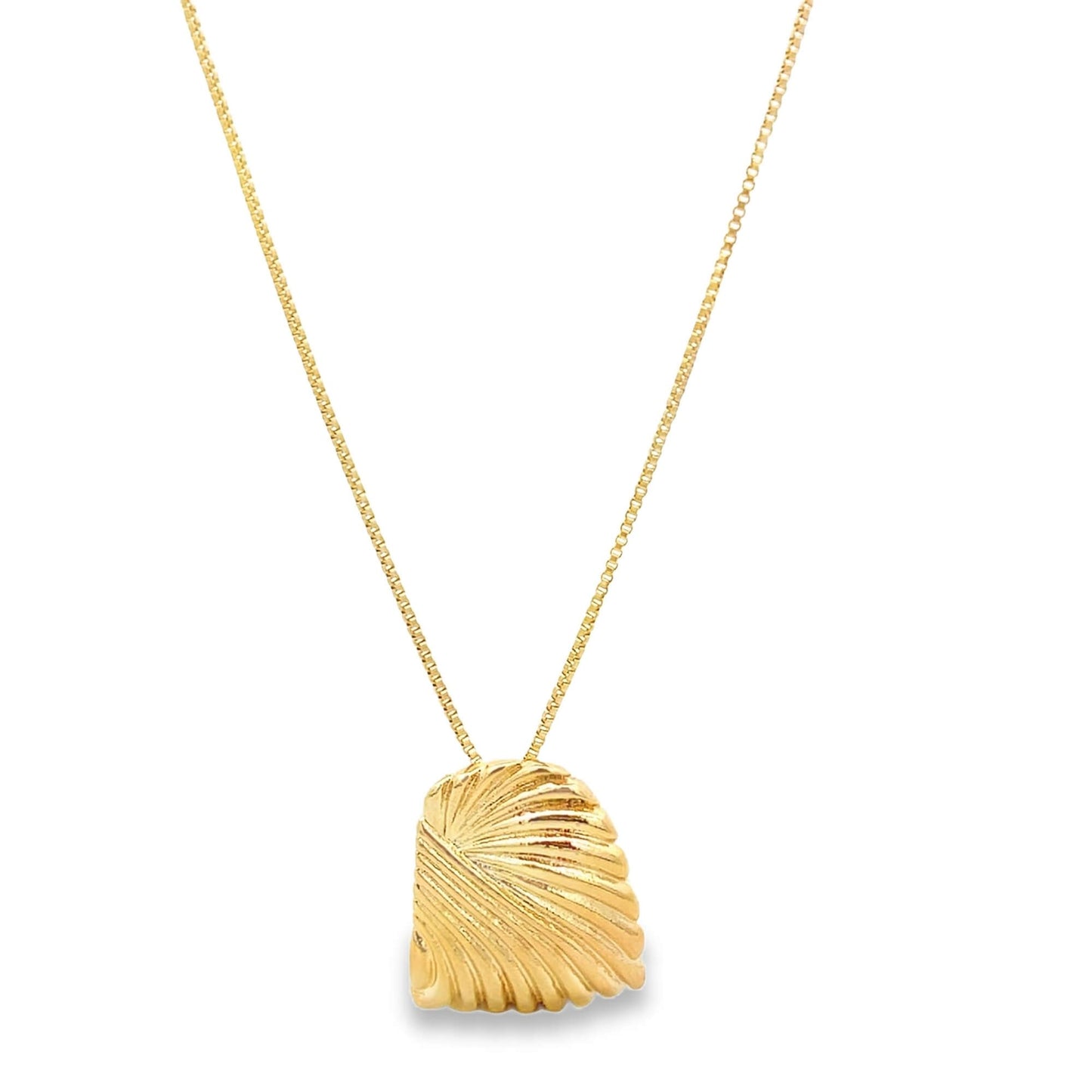 A delicate gold chain holds a textured, shell-shaped pendant against a plain background.