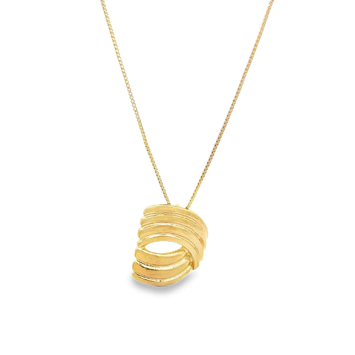 A delicate gold chain holds a chunky, ribbed spiral pendant against a plain white background.