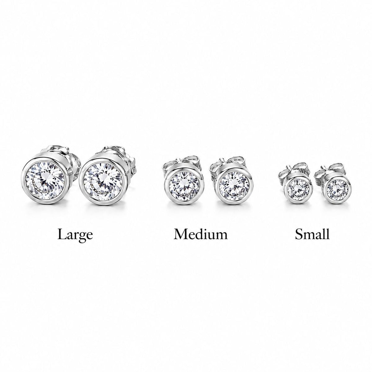 Three pairs of bezel-set diamond stud earrings display large, medium, and small sizes side by side against a white background.
