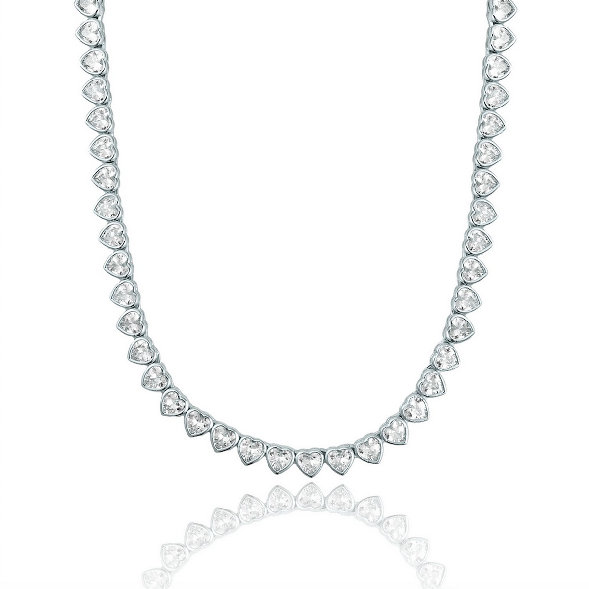 A silver heart-shaped tennis necklace sparkles against a clean white background, reflecting its glittering gemstones below.