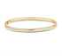 A polished yellow gold bangle bracelet sparkles with two delicate rows of pavé-set diamonds.