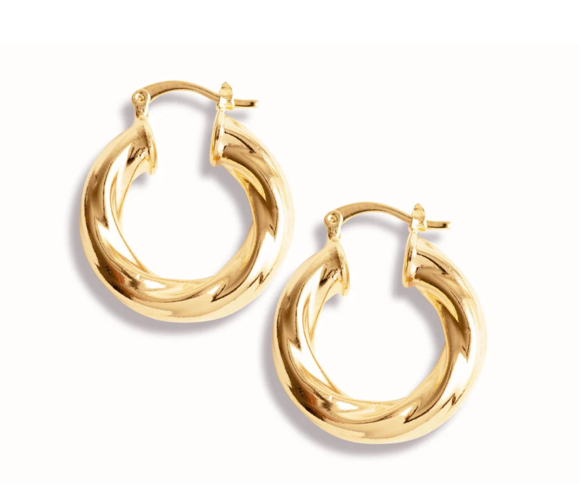 A pair of polished thick gold twist hoop earrings display their shiny metallic texture against a clean white background.