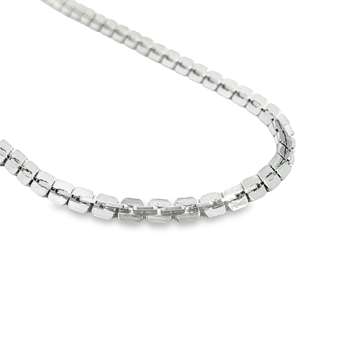 A gleaming silver box chain displays its interlocking square links in a gentle curve on a clean white background.