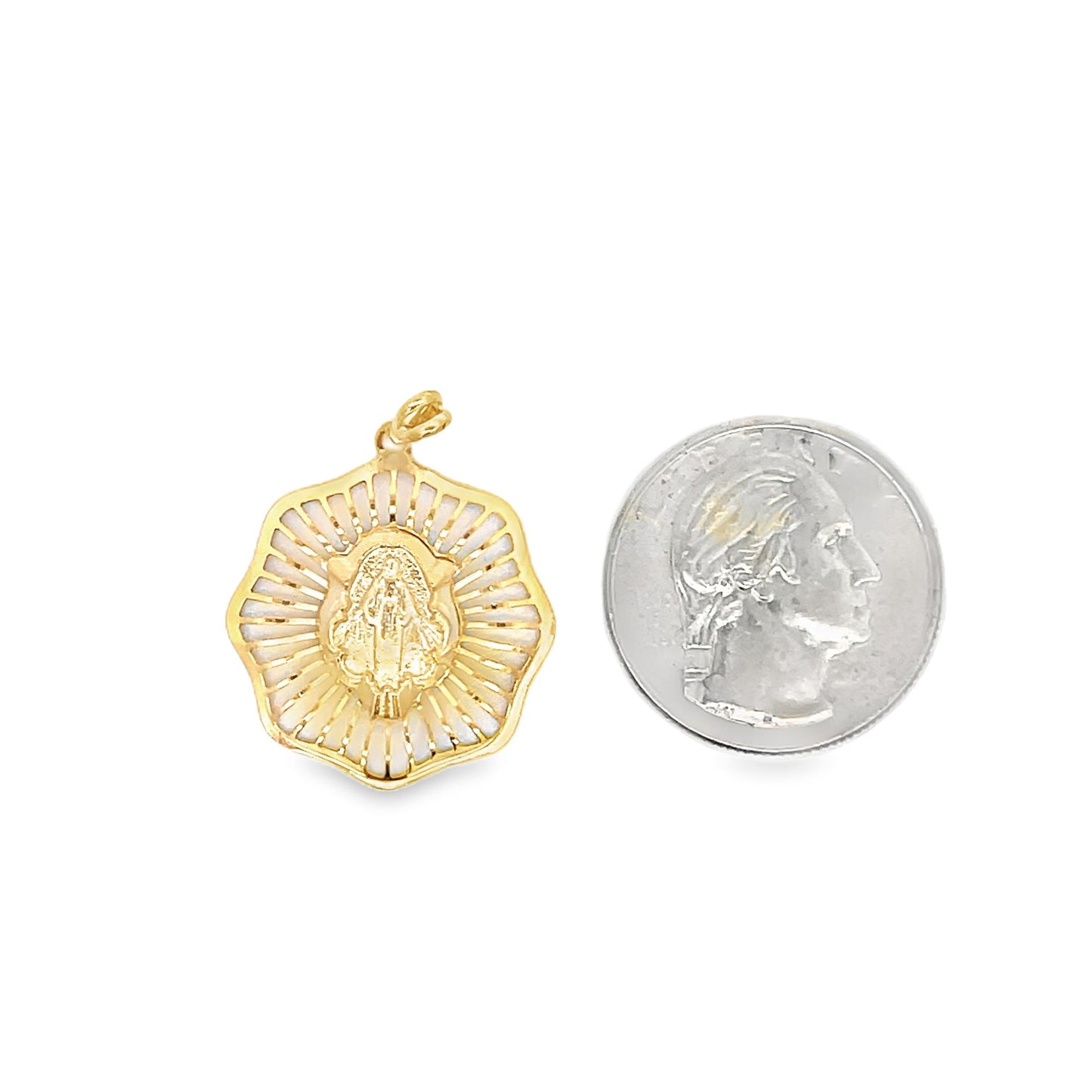A gold Our Lady of Guadalupe pendant rests next to a US quarter coin for size comparison on a white background.