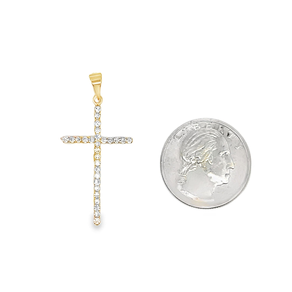 A diamond-studded gold cross pendant sits next to a US quarter coin for size comparison on a white background.