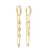 A pair of gold huggie hoop earrings featuring pavé diamonds and delicate dangling chains with bezel-set stones.
