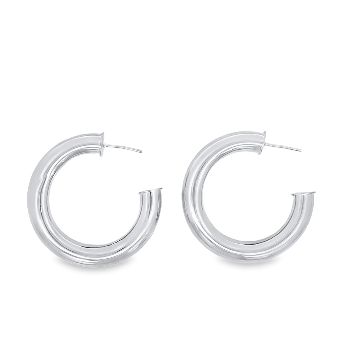 A pair of polished sterling silver chunky hoop earrings rests against a clean white background.