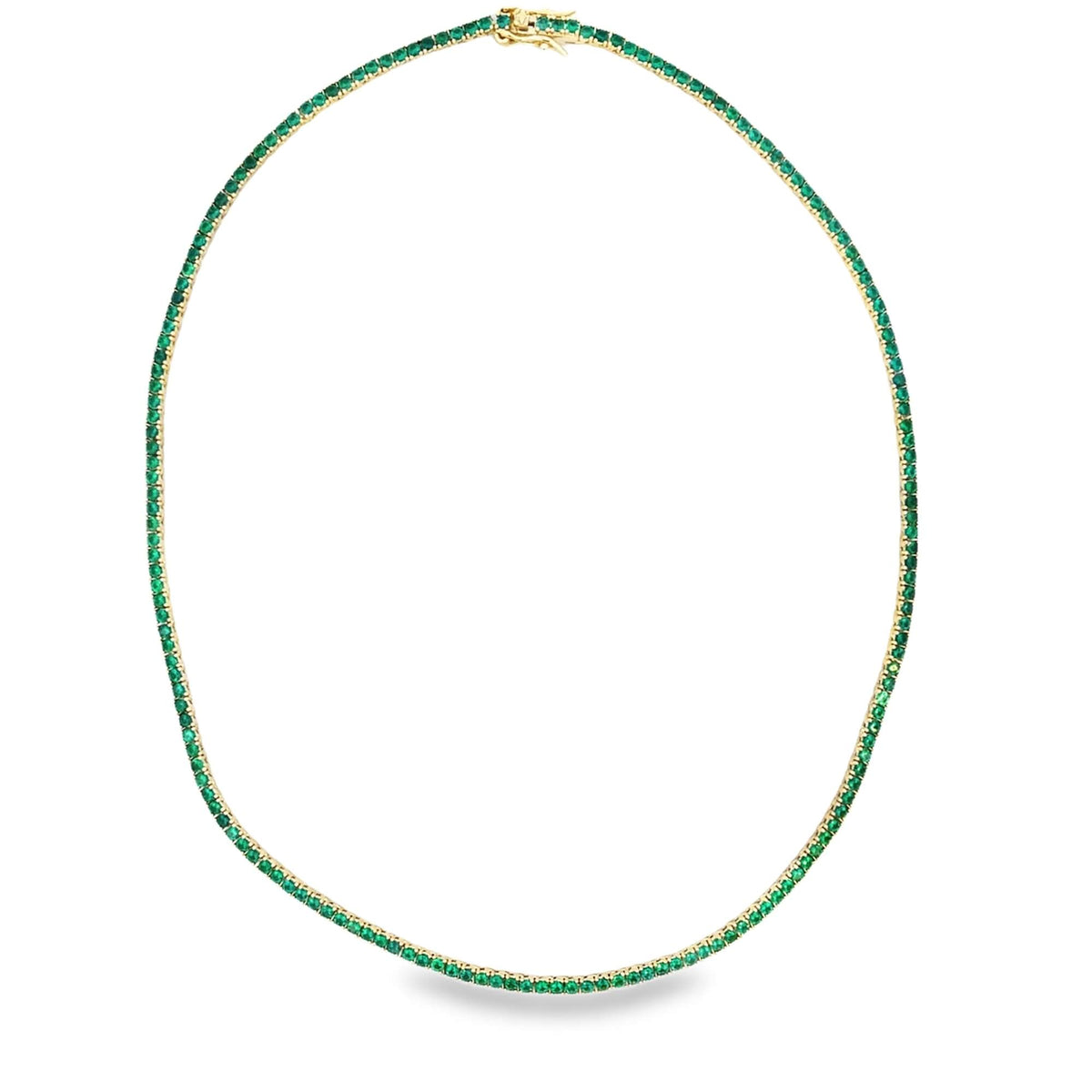 A delicate gold tennis necklace sparkles with vibrant green gemstones arranged in a continuous circle against a clean white background.