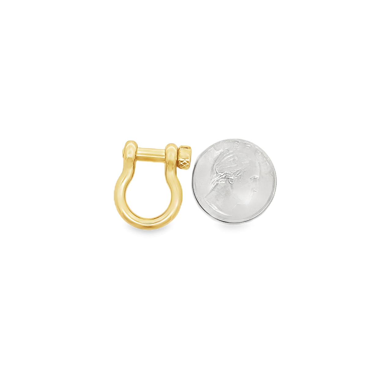 A gold shackle charm rests beside a US dime to display its scale.