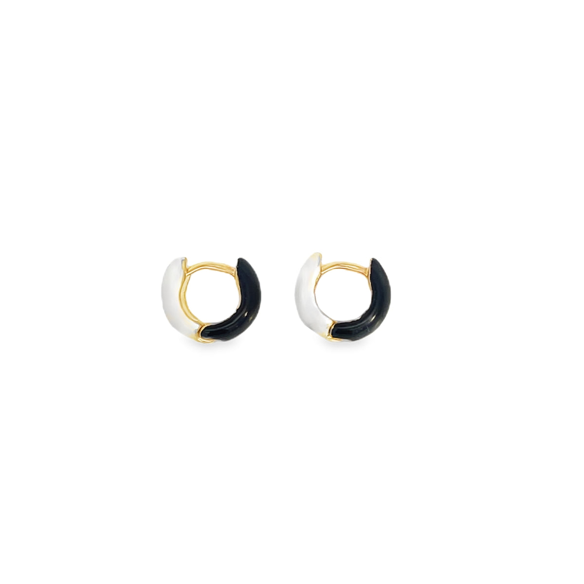 A pair of gold huggie hoop earrings featuring split enamel designs in glossy black and white.