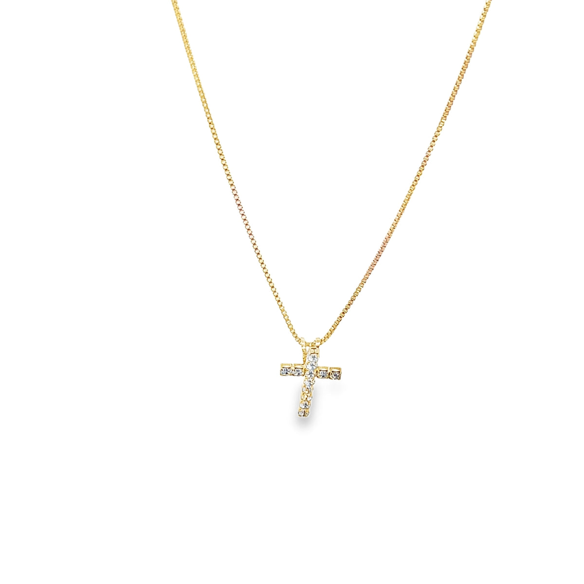 A delicate gold cross necklace sparkling with embedded diamonds hangs on a fine gold chain against a white background.
