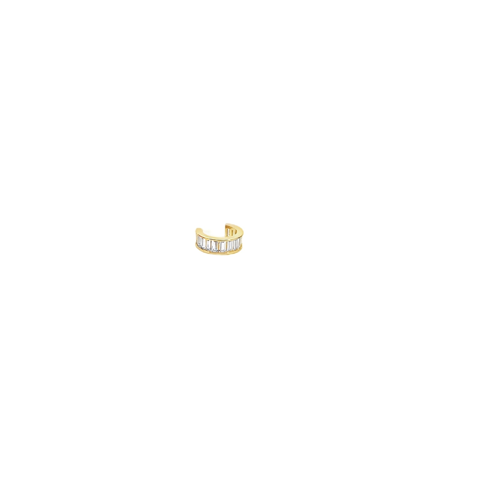 A sleek gold ear cuff sparkles with a row of baguette-cut diamonds against a clean white background.
