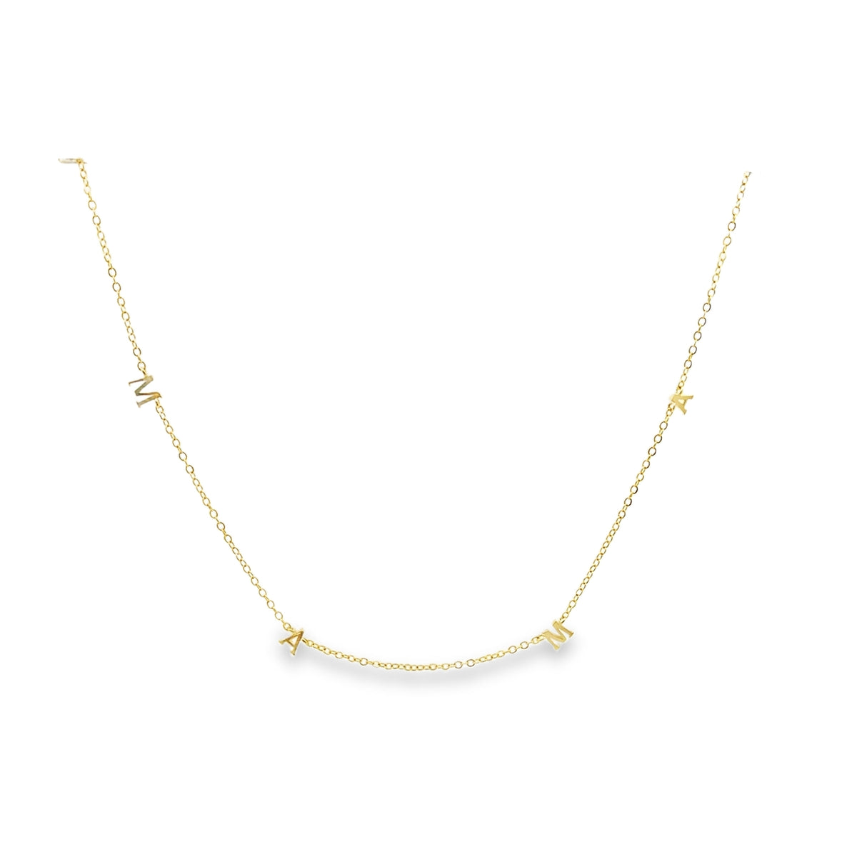 A delicate gold chain necklace spells out the word MAMA with individual letter charms spaced along the metal links.