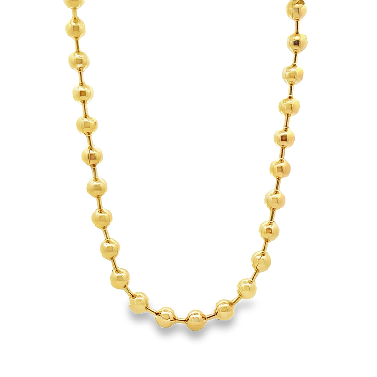 A polished gold ball chain necklace drapes gracefully against a white background.
