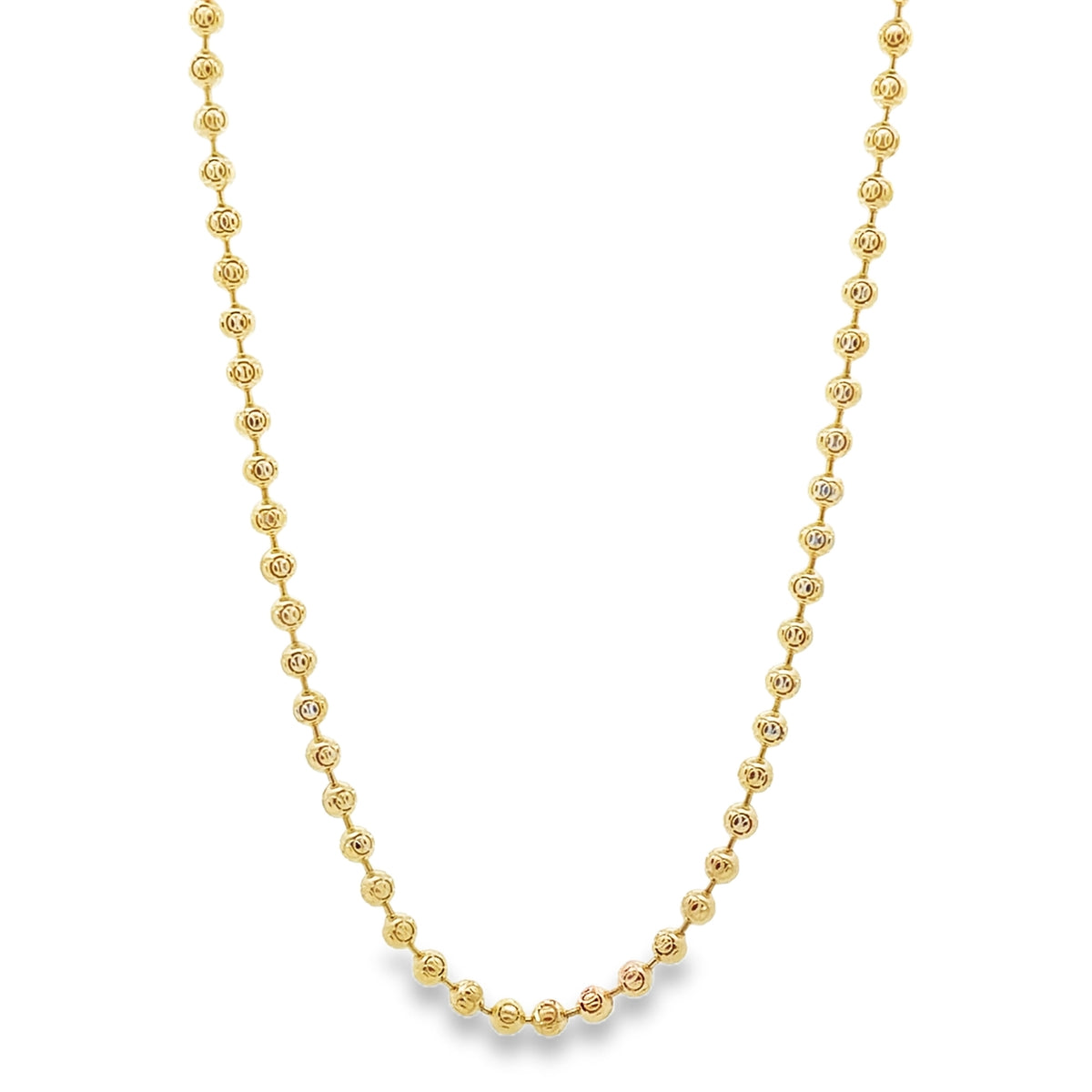 A delicate gold bead chain necklace drapes gracefully against a white background.
