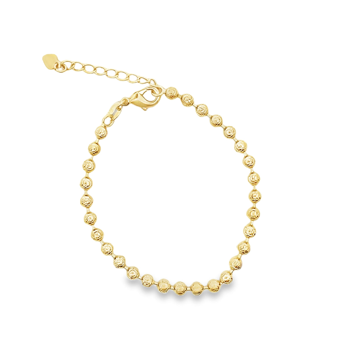 A delicate gold bead bracelet curves gracefully against a clean white background, showcasing its sparkling texture and secure lobster clasp.