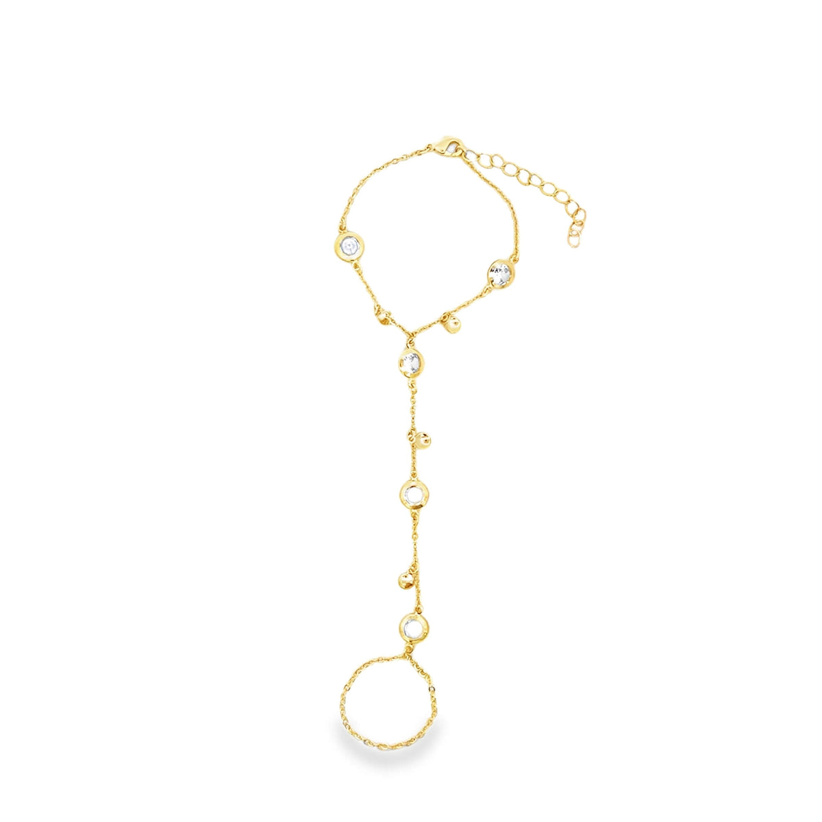 A delicate gold slave bracelet features sparkling bezel-set crystals and connects a wrist chain to a finger ring against a clean white background.