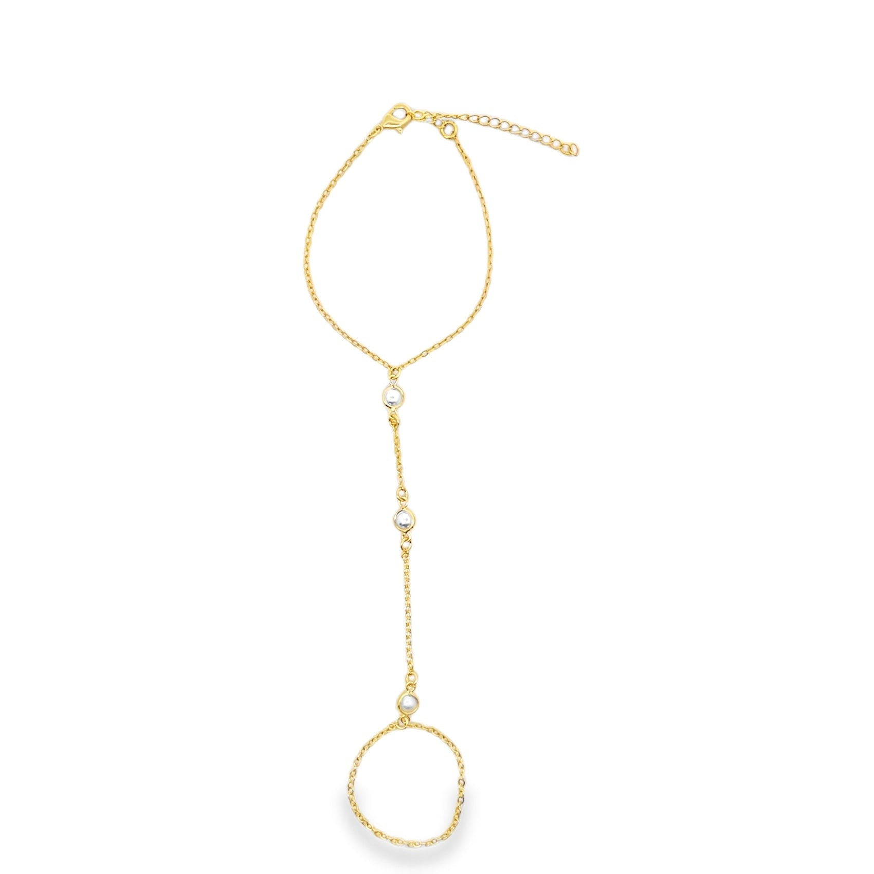 A delicate gold slave bracelet features a connected ring and wrist chain accented with small white pearls against a plain white background.