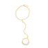 A delicate gold hand chain bracelet sparkles against a white background, featuring a slender mariner link chain connecting a wrist bracelet to an adjustable finger ring.