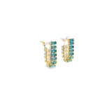 huggie earrings with blue baguette cubic zirconia stones. Modern crystal huggies with a sleek vertical design.