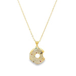 Modern gold open circle pendant necklace featuring pavé cubic zirconia stones. A minimalist yet eye-catching necklace perfect for layering or everyday wear.