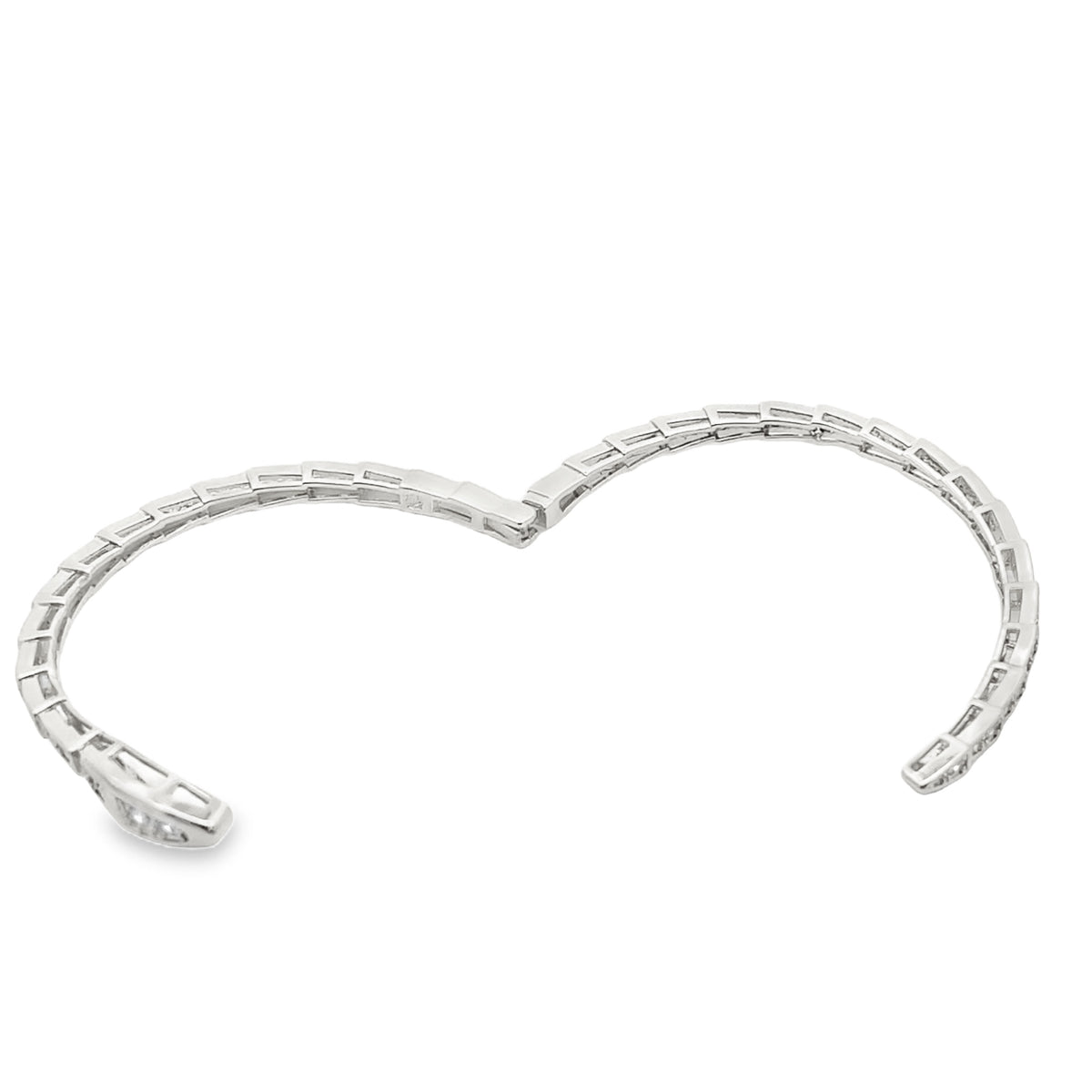 A delicate silver diamond cuff bracelet sparkles against a clean white background.