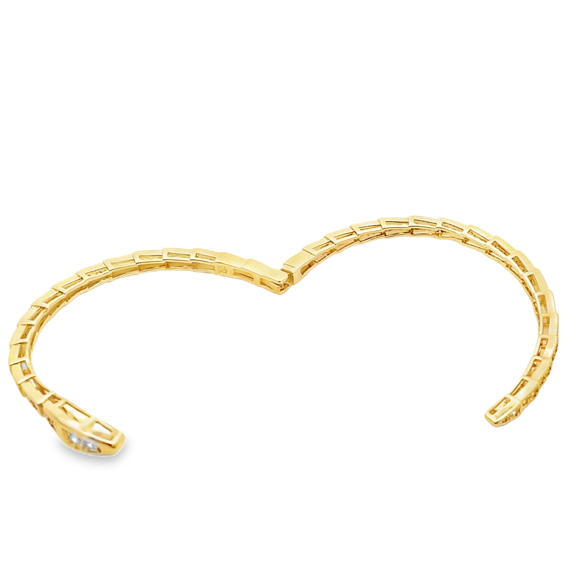 A flexible gold snake bracelet curves gracefully against a white background, showcasing its segmented, scaly design.