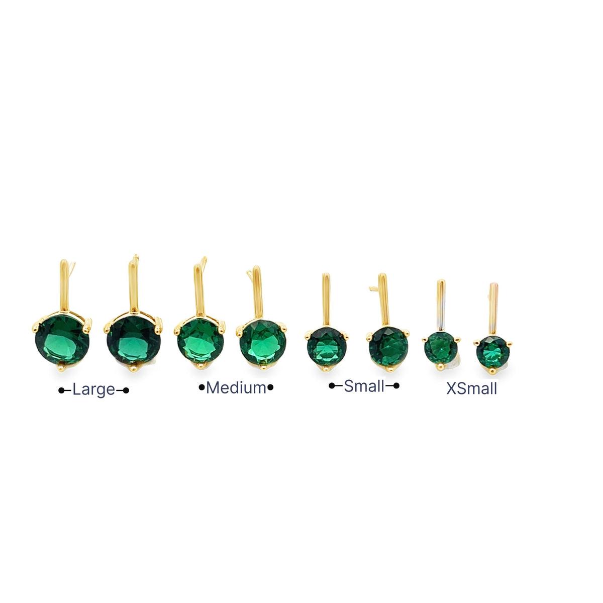 A lineup of gold huggie earrings featuring vibrant green emerald cubic zirconia stones displayed in size options from extra small to large.