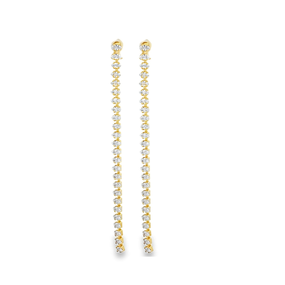 A pair of long, elegant gold drop earrings sparkles with vertically set pavé diamonds against a clean white background.