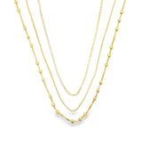 Elegant triple layer necklace featuring baguette, box and beaded chains. Minimalist layered jewelry available in gold or silver. Perfect for everyday wear.