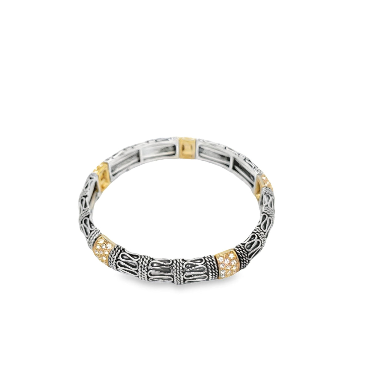 A detailed silver and gold Bali-style stretch bracelet features intricate filigree patterns and sparkling crystal accents on a plain white background.
