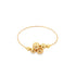 A thin yellow gold bangle bracelet features an asymmetrical cluster of polished spherical beads in graduating sizes.