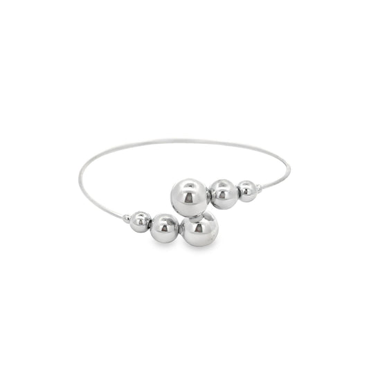 A sleek silver cuff bracelet features staggered polished metallic spheres on a clean white background.