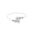 A sleek silver bangle bracelet features an arrangement of polished metallic spheres.