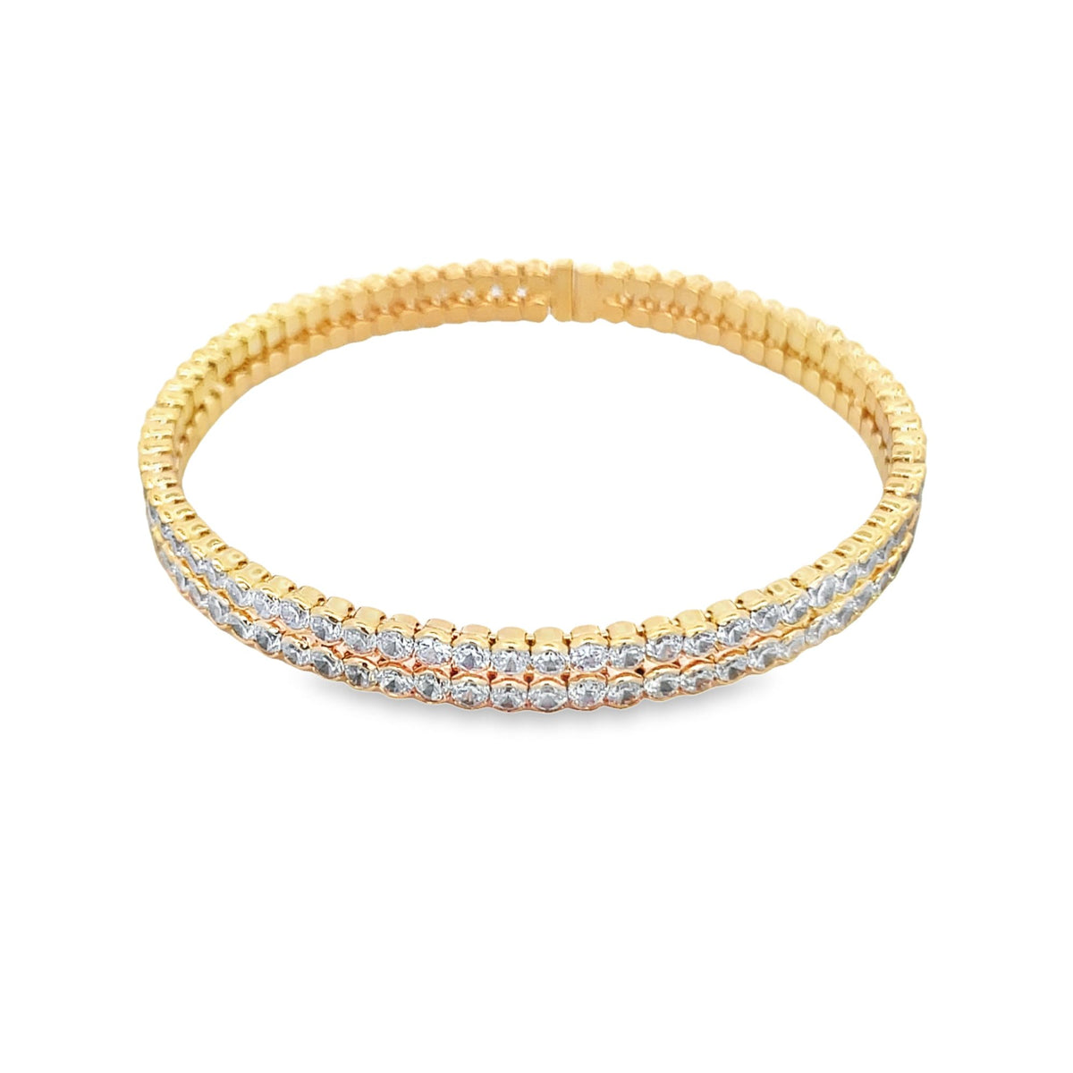A double row of sparkling diamonds encrusts a sleek gold bangle bracelet displayed against a clean white background.