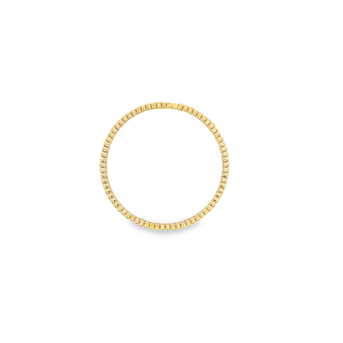 A delicate gold tennis necklace lies in a perfect circle on a clean white background.