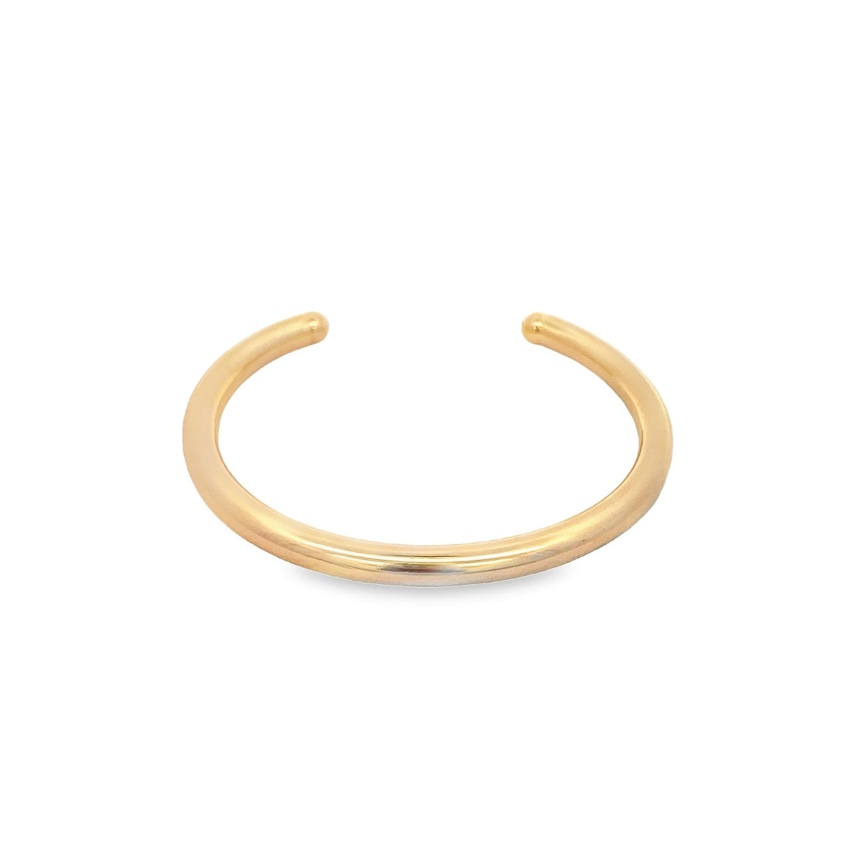 A minimalist gold cuff bracelet rests against a clean white background.